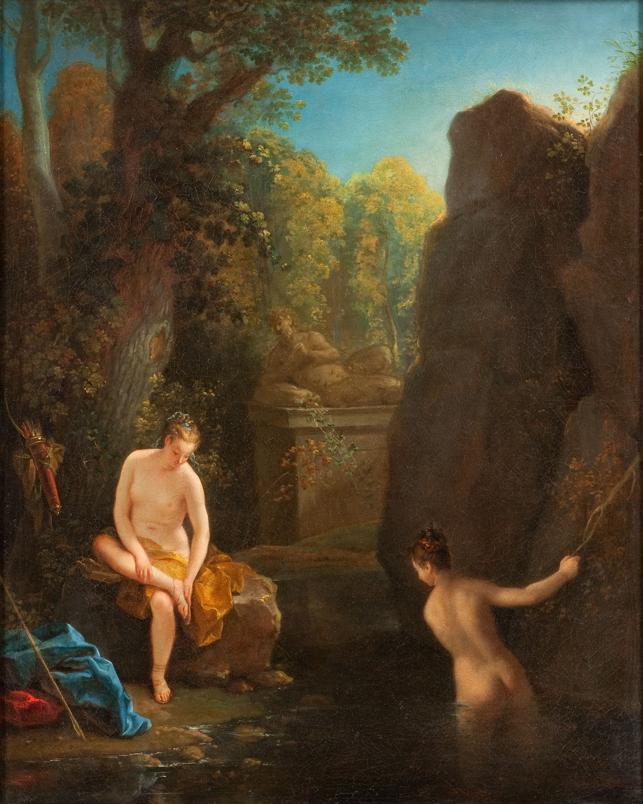 Cette image représente une scène de nature paisible et idéalisée. On y voit deux femmes nues près d'un point d'eau. L'une est assise sur un rocher, portant un drapé de couleur jaune, tandis que l'autre est dans l'eau, semblant s'approcher de la première. Les deux figures sont entourées d'une verdure luxuriante, avec des arbres et des rochers qui créent une ambiance romantique. À l'arrière-plan, on aperçoit une structure en pierre, ajoutant un élément architectural à la composition. L'ensemble dégage une atmosphère de sérénité et de douceur.