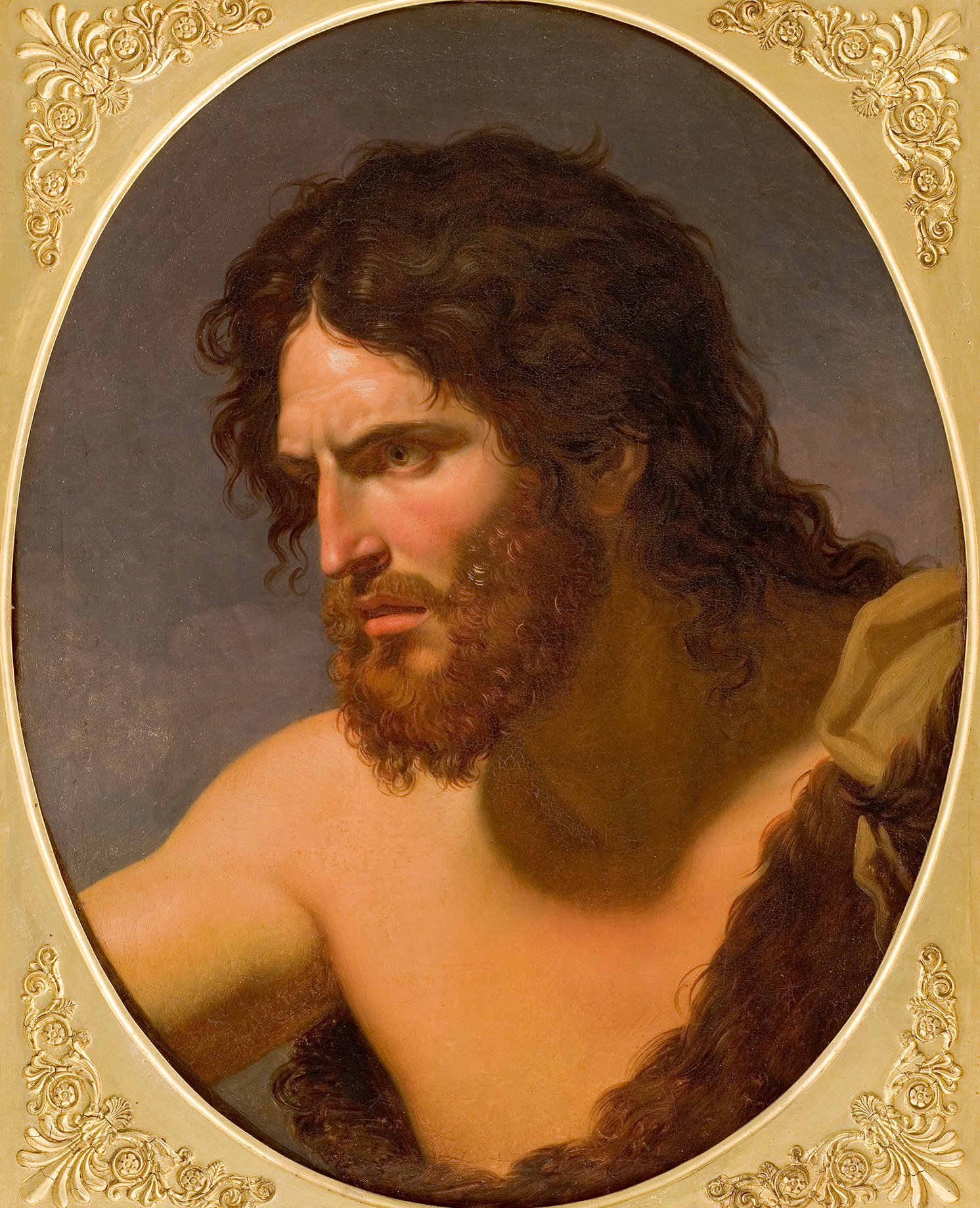 L'image représente un homme aux traits marqués, avec des cheveux longs et une barbe fournie. Il a une expression intense et concentrée, reflétant des émotions profondes. Son corps est dénudé, ce qui met en avant sa musculature. Le fond est sombre, contrastant avec son visage et sa peau. Le portrait est encadré dans un cadre doré orné, ce qui lui donne un aspect artistique et classique.