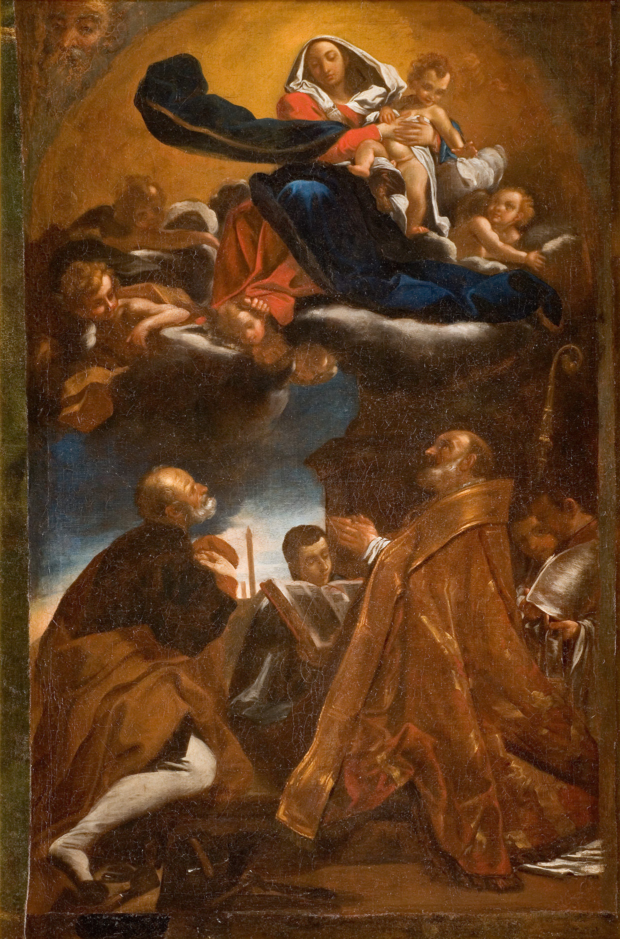 L'image représente une scène religieuse, probablement une composition baroque, où la Vierge Marie est montrée en haut, tenant l'Enfant Jésus dans ses bras. Elle est entourée d'anges ou de figures célestes flottant sur des nuages. En bas, plusieurs saints ou personnages religieux sont en posture de prière, les yeux levés vers Marie et Jésus, montrant un sentiment de dévotion. L'arrière-plan suggestif et les drapés colorés ajoutent à l'intensité spirituelle de l'œuvre. Les expressions des personnages transmettent une profonde révérence.