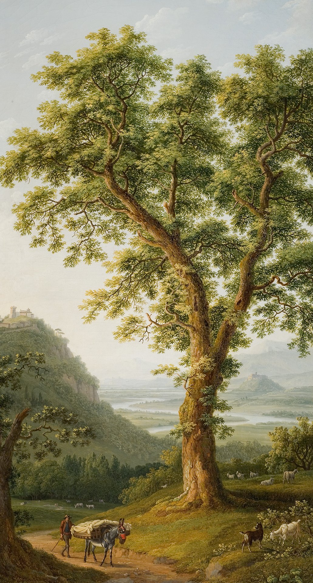 L'image représente un paysage pastoral. Au premier plan, un grand arbre feuillu s'élève majestueusement, ses branches s'étendant largement. Un homme, portant un fardeau sur son dos, marche avec un âne à ses côtés. En arrière-plan, on peut voir une vallée verdoyante avec des collines, des champs et quelques vaches paissant. À l'horizon, des bâtiments sont visibles sur une colline, suggérant la présence d'un village ou d'un château. Le ciel est clair et lumineux, apportant une atmosphère paisible à la scène.