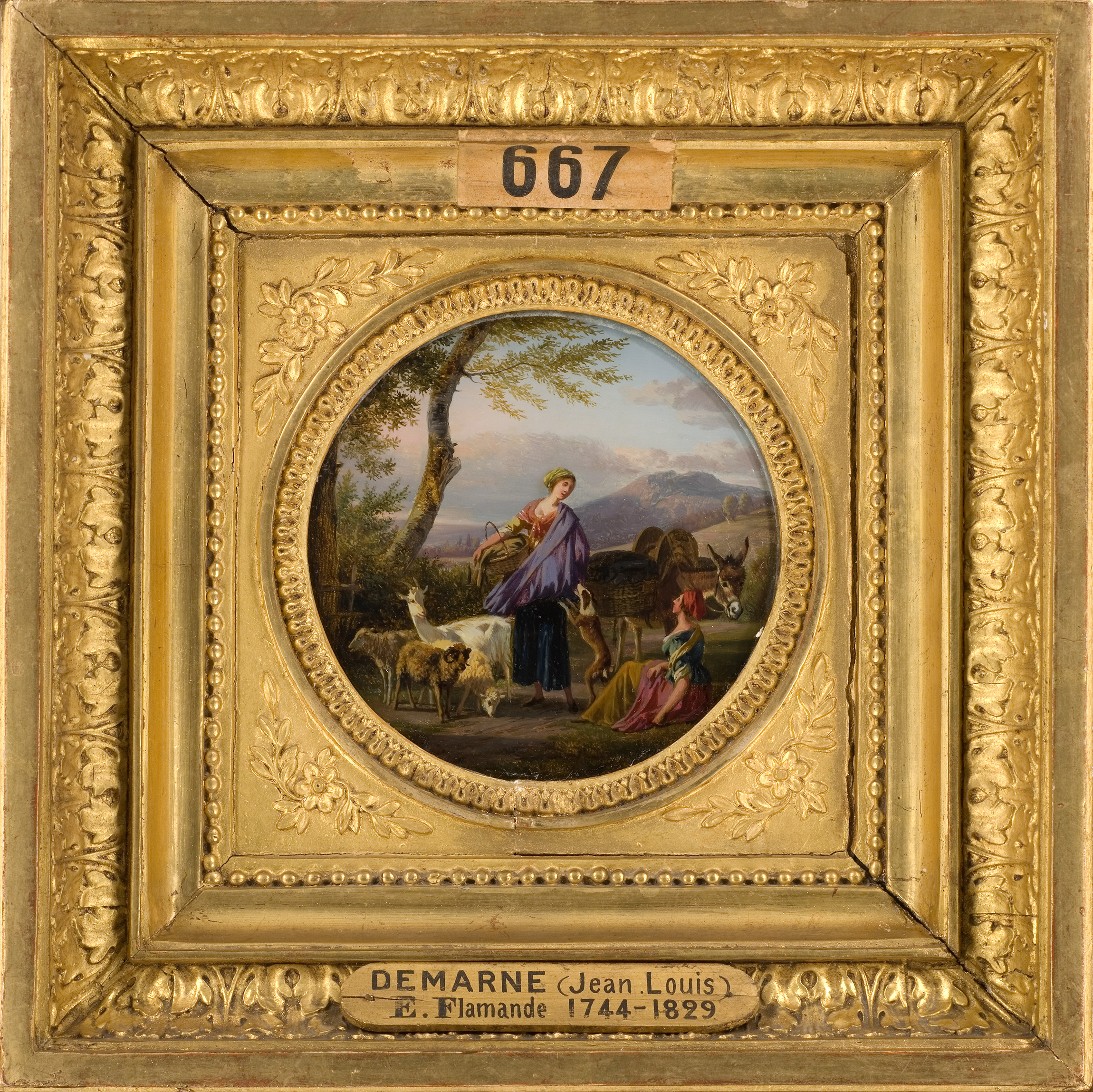 L'image montre un tableau encadré avec un décor doré. Le tableau lui-même représente une scène pastorale avec des personnages, dont une femme habillée de manière colorée, en interaction avec des animaux, probablement des chèvres ou des moutons. Le paysage en arrière-plan est doux et bucolique, avec des arbres et des collines, ce qui évoque un cadre rural tranquille. Le nom de l'artiste, Jean-Louis Demarne, est inscrit en bas du cadre, et le tableau semble remonter à la période flamande du XVIIIe siècle.