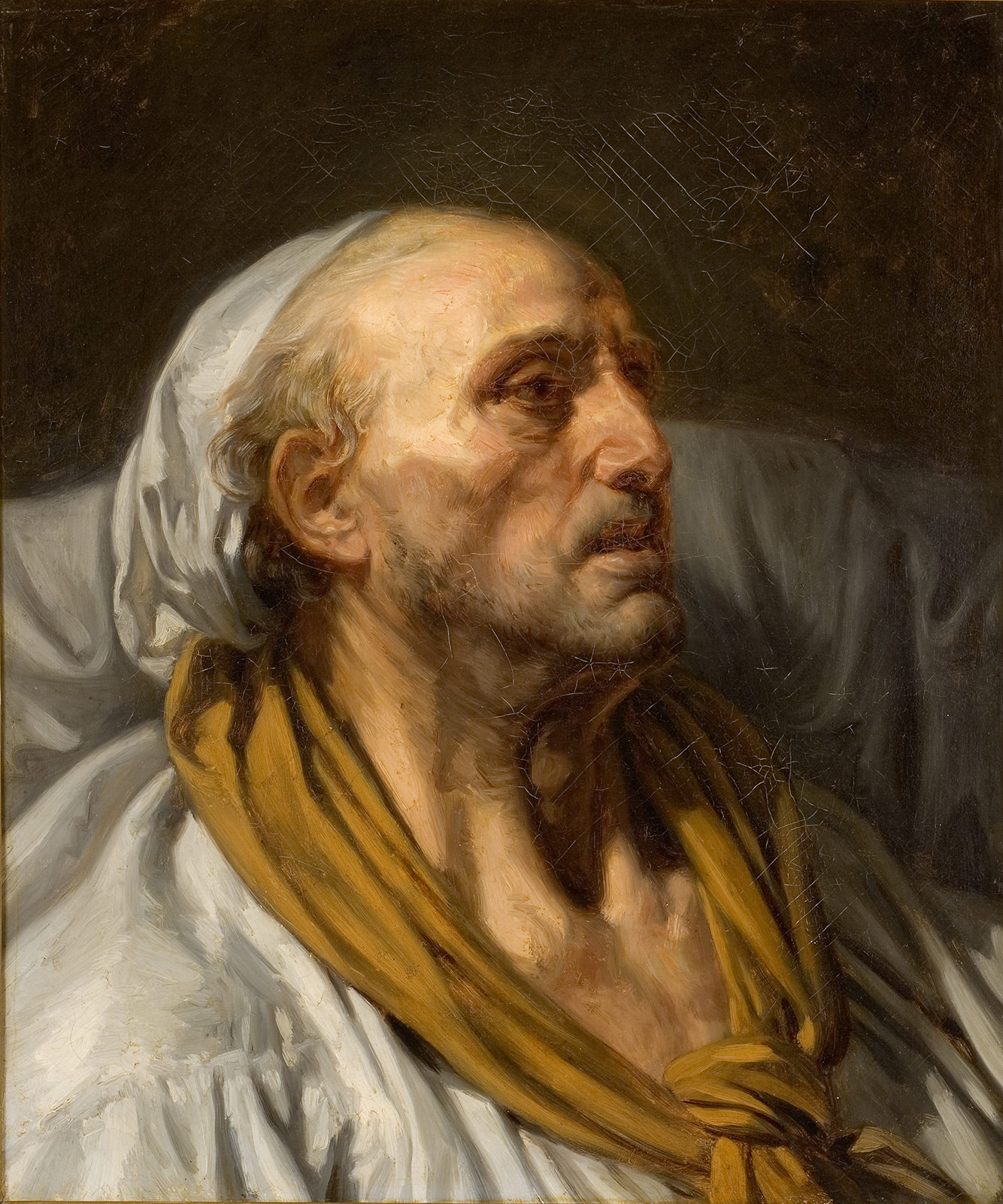 Cette image représente un portrait d'un homme âgé, probablement malade ou en phase terminale. Il est allongé sur un lit, avec le visage légèrement tourné vers le haut, ce qui laisse transparaître une expression de réflexion ou de tristesse. Sa peau est marquée par le temps, et il porte une coiffe blanche ainsi qu'une écharpe ou un foulard orange autour du cou. L'éclairage est dramatique, mettant en valeur les traits de son visage et créant une atmosphère intense et émotive. L'arrière-plan est sombre, ce qui accentue la solitude et la vulnérabilité du personnage.