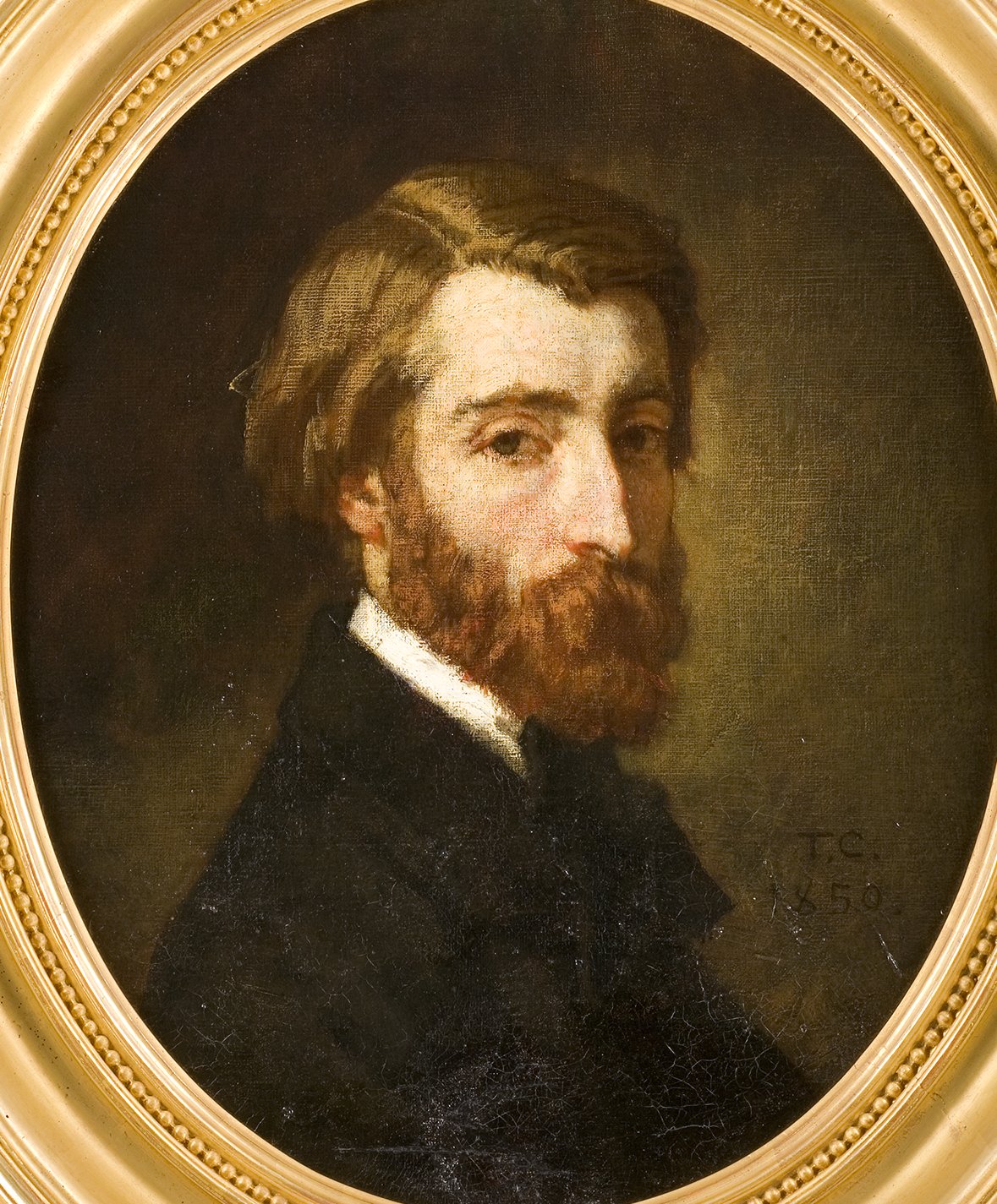 Cette image représente un portrait d'un homme, probablement réalisé au XIXe siècle, avec un style artistique classique. L'homme a les cheveux ondulés et une barbe, portant un manteau sombre. Son regard est tourné légèrement vers la droite, et le fond est sombre, ce qui met en valeur le personnage. Le cadre est en or, ajoutant une touche d'élégance à l'œuvre. La date "1856" et les initiales "T.C." sont visibles sur le tableau, suggérant le nom de l'artiste et l'année de création.