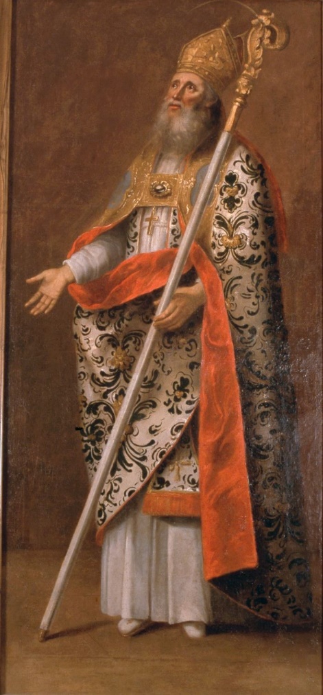 L'image montre un personnage vêtu d'une somptueuse robe ornée de motifs complexes, avec une grande cape qui ajoute à son allure majestueuse. Il porte une mitre sur la tête, symbole de son autorité religieuse, et tient un bâton pastoral dans une main, ce qui indique également son rôle ecclésiastique. Son expression est sérieuse et contemplative, ajoutant à l'impression de dignité et de respect qu'il dégage. Le fond sobre met en valeur son costume richement décoré, accentuant le contraste entre la simplicité du décor et l'opulence de son habillement.