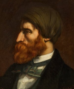 Cette image représente un portrait d'un homme en profil. Il a une chevelure brune, légèrement ondulée, et une barbe fournie de la même teinte. L'homme porte un vêtement sombre, probablement une veste ou un manteau, ainsi qu'une cravate ou un nœud papillon coloré. Le fond est sombre, ce qui met en valeur les traits du visage et la texture de sa barbe. Ce portrait dégage une certaine intensité et une profondeur dans l'expression.